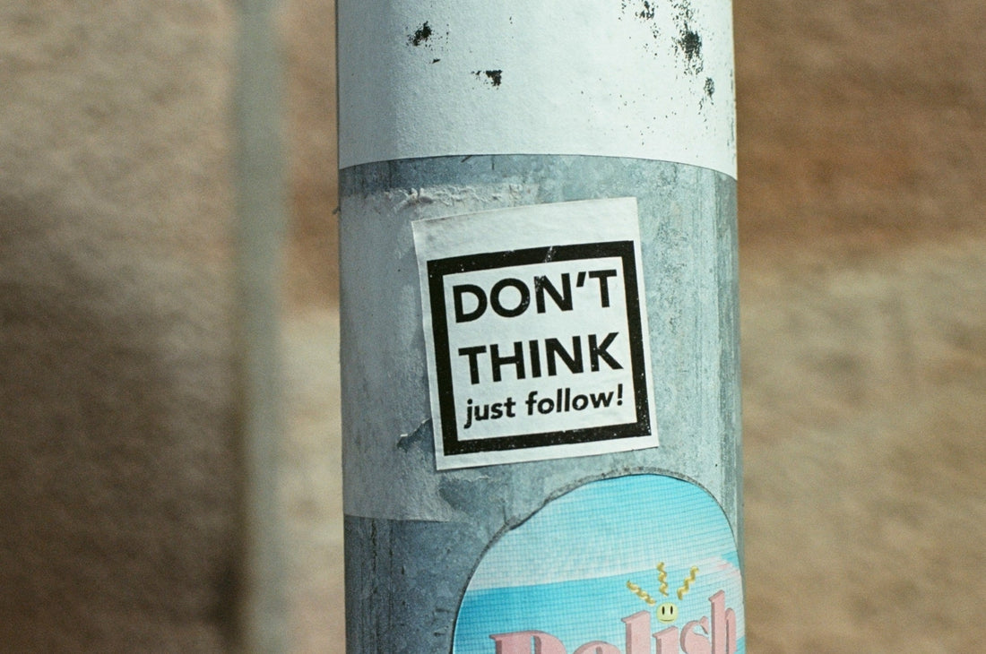 lampost with a ticker that says don't think just follow on it