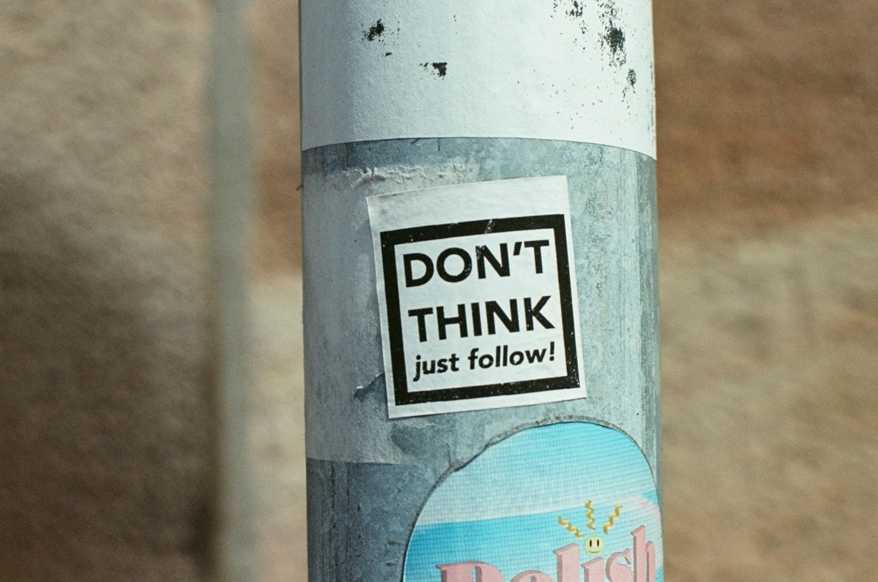 lampost with a ticker that says don't think just follow on it